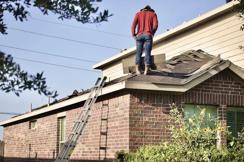 Professional roofer working on a residential roof in Cobblestone East